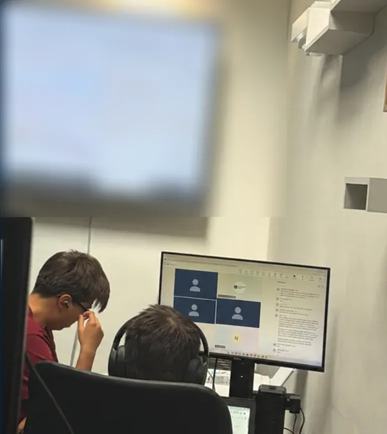 Placement students working on technology tasks in the Core Guard Group office.